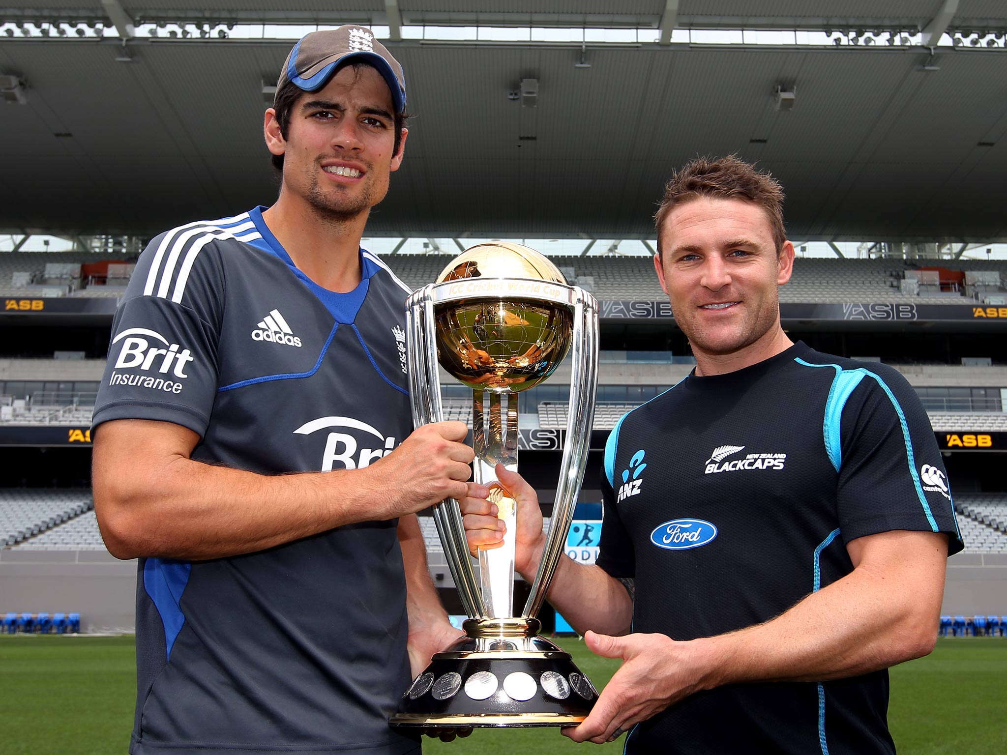 England captain Alastair Cook (left) and New Zealand captain Brendon McCullum (right) pose with the Cricket World Cup Trophy