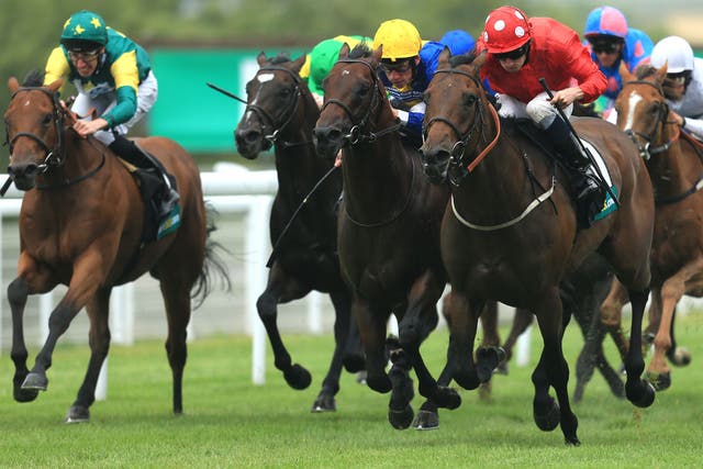 Ryan Moore (red) delivers Garswood late to land the Lennox Stakes