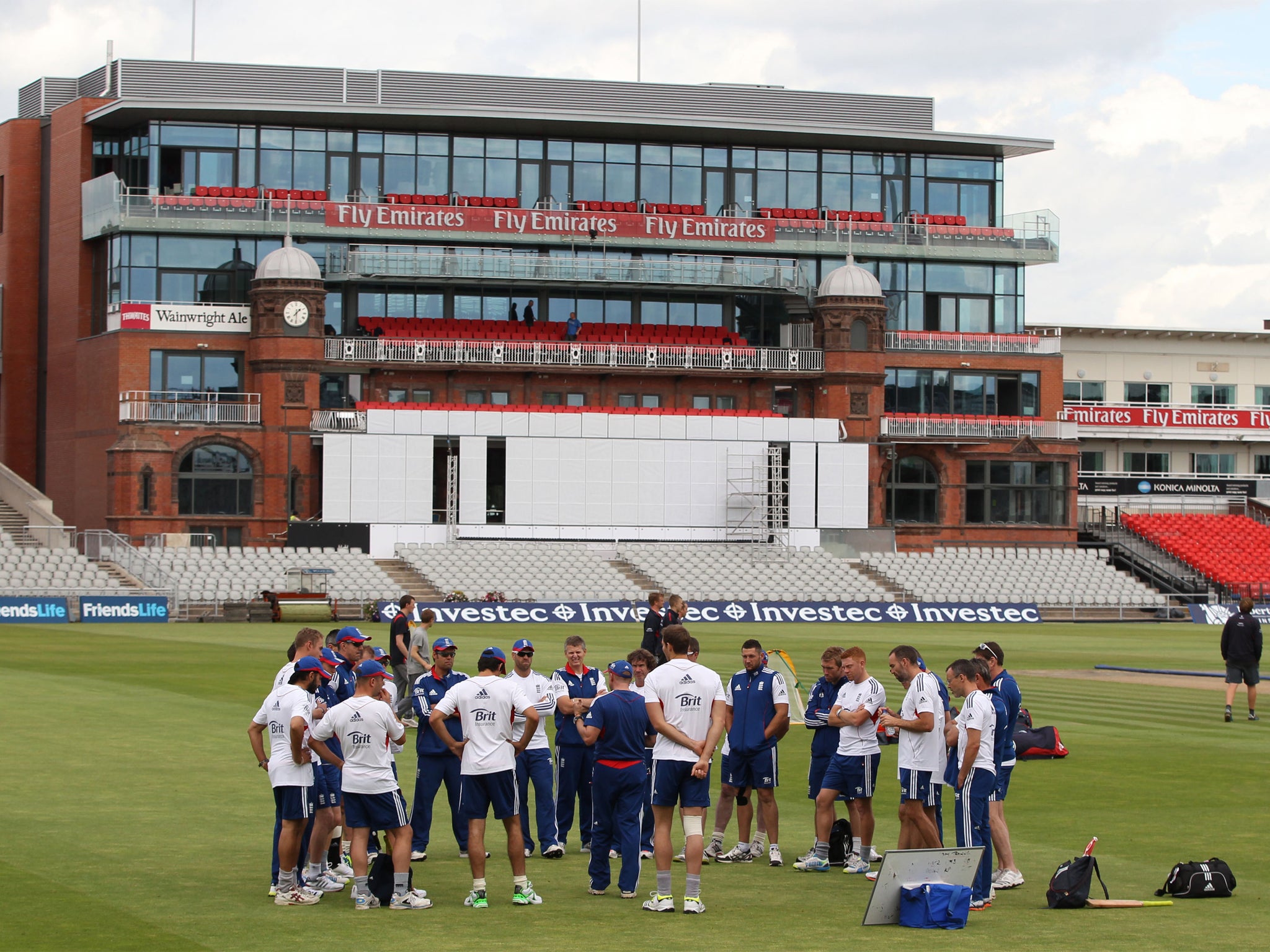 England hold a team-talk in front of the new-look pavilion