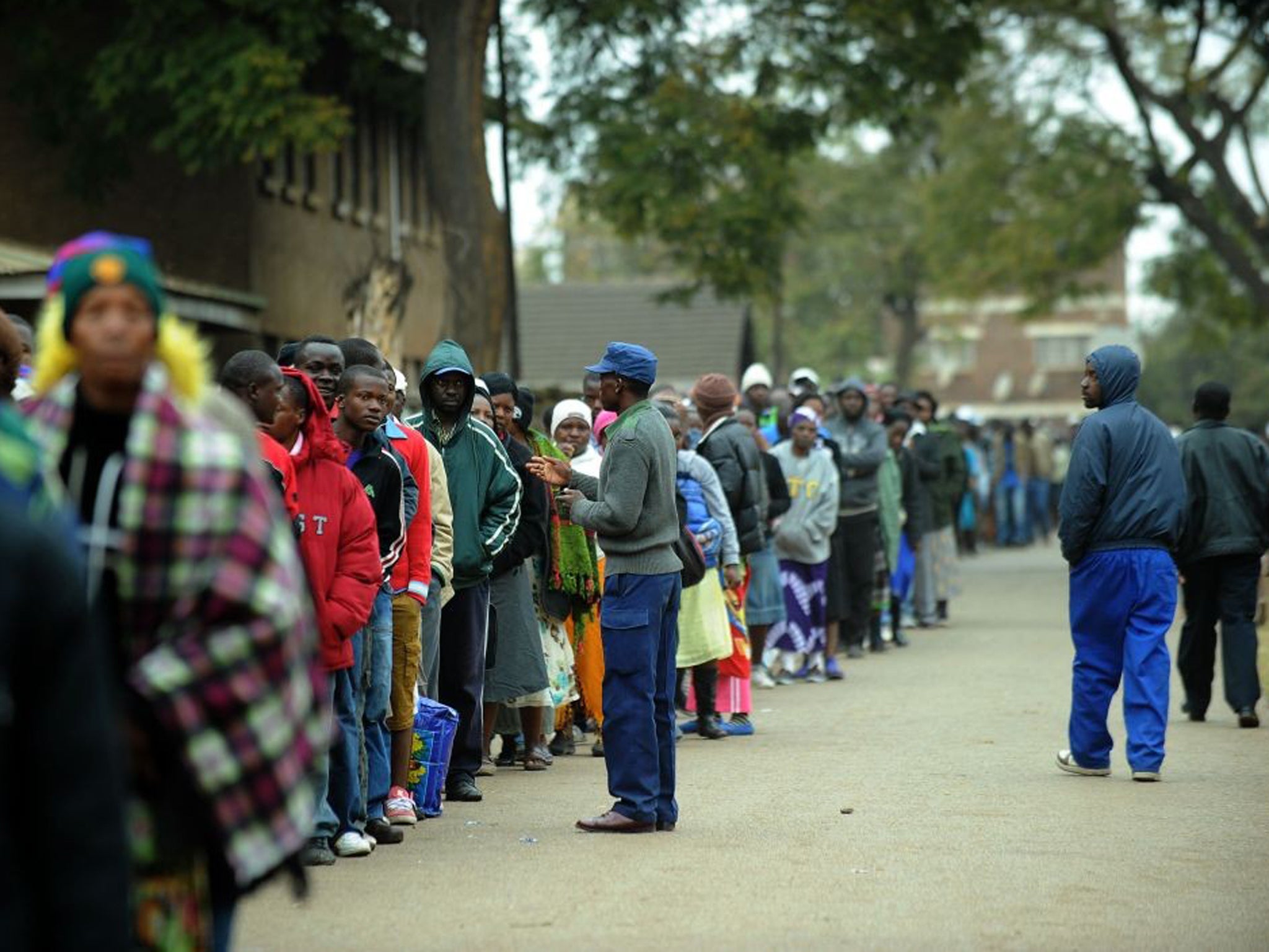 Zimbabweans line up near a polling station in Harare