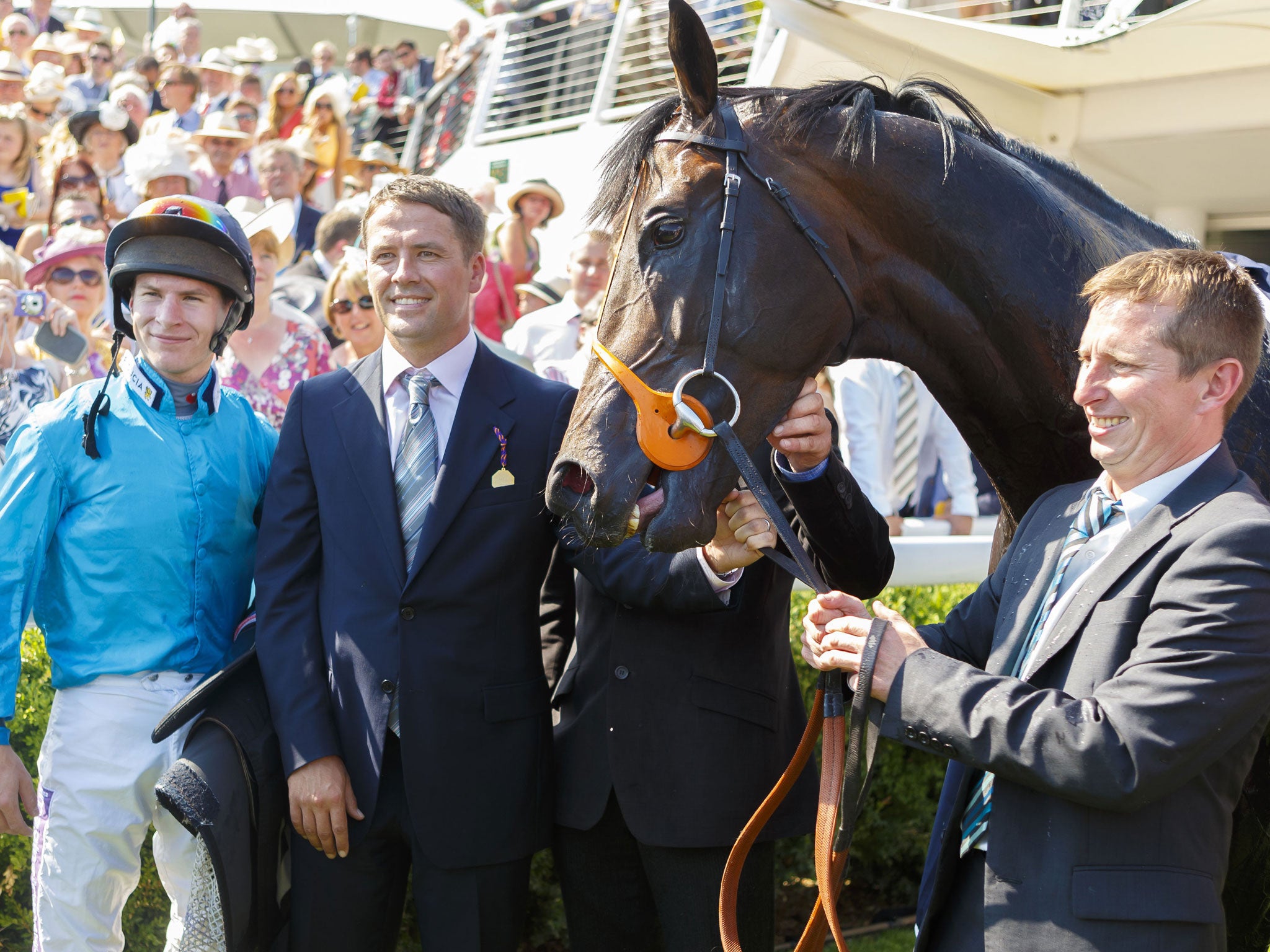 Owner Michael Owen (second left) and jockey Richard Kingscote with Brown Panther after his Goodwood Cup win yesterday