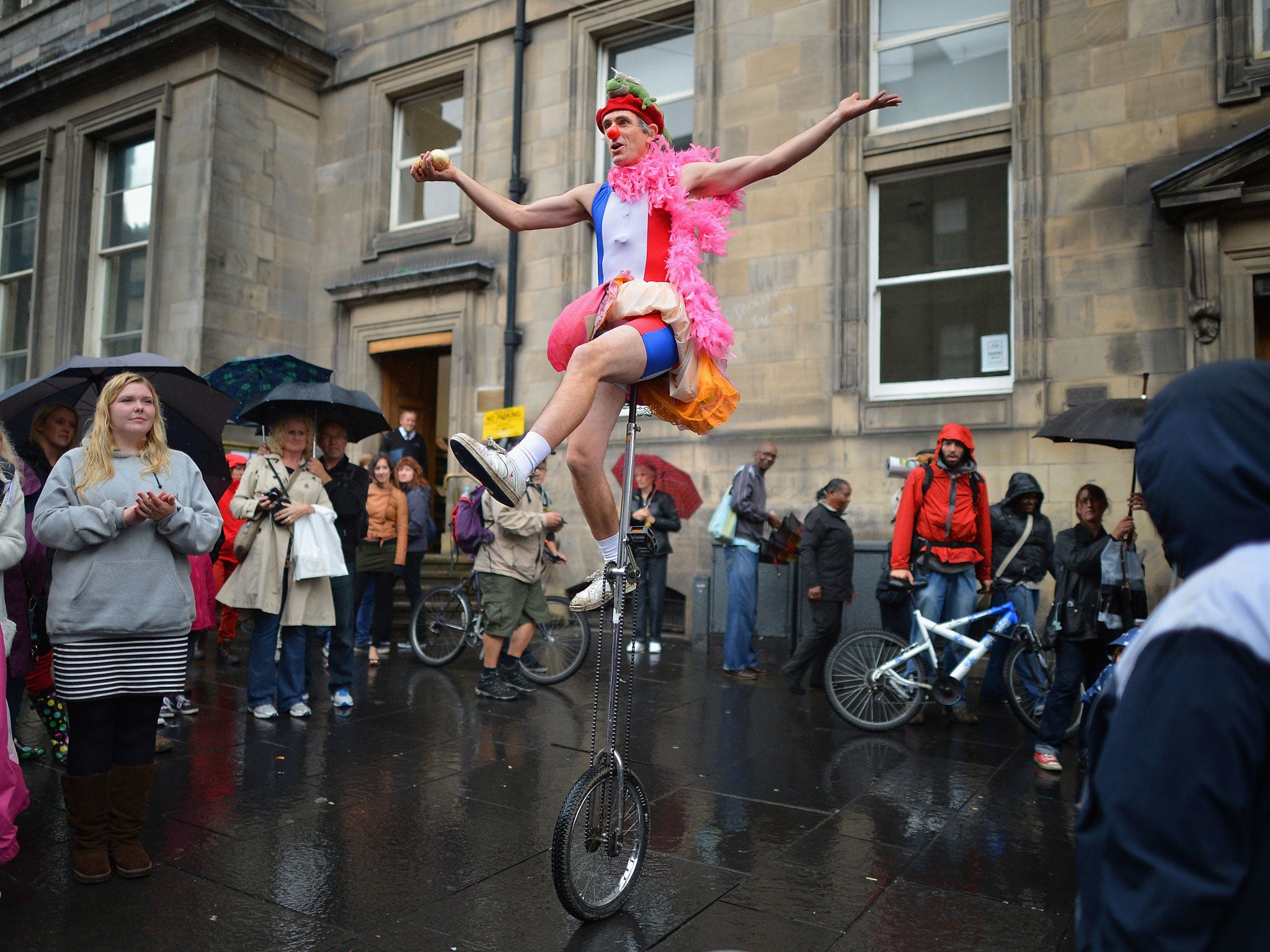 Street entertainers perform on the Royal Mile on the final day of the Edinburgh Festival Fringe on August 27, 2012 in Edinburgh, Scotland.