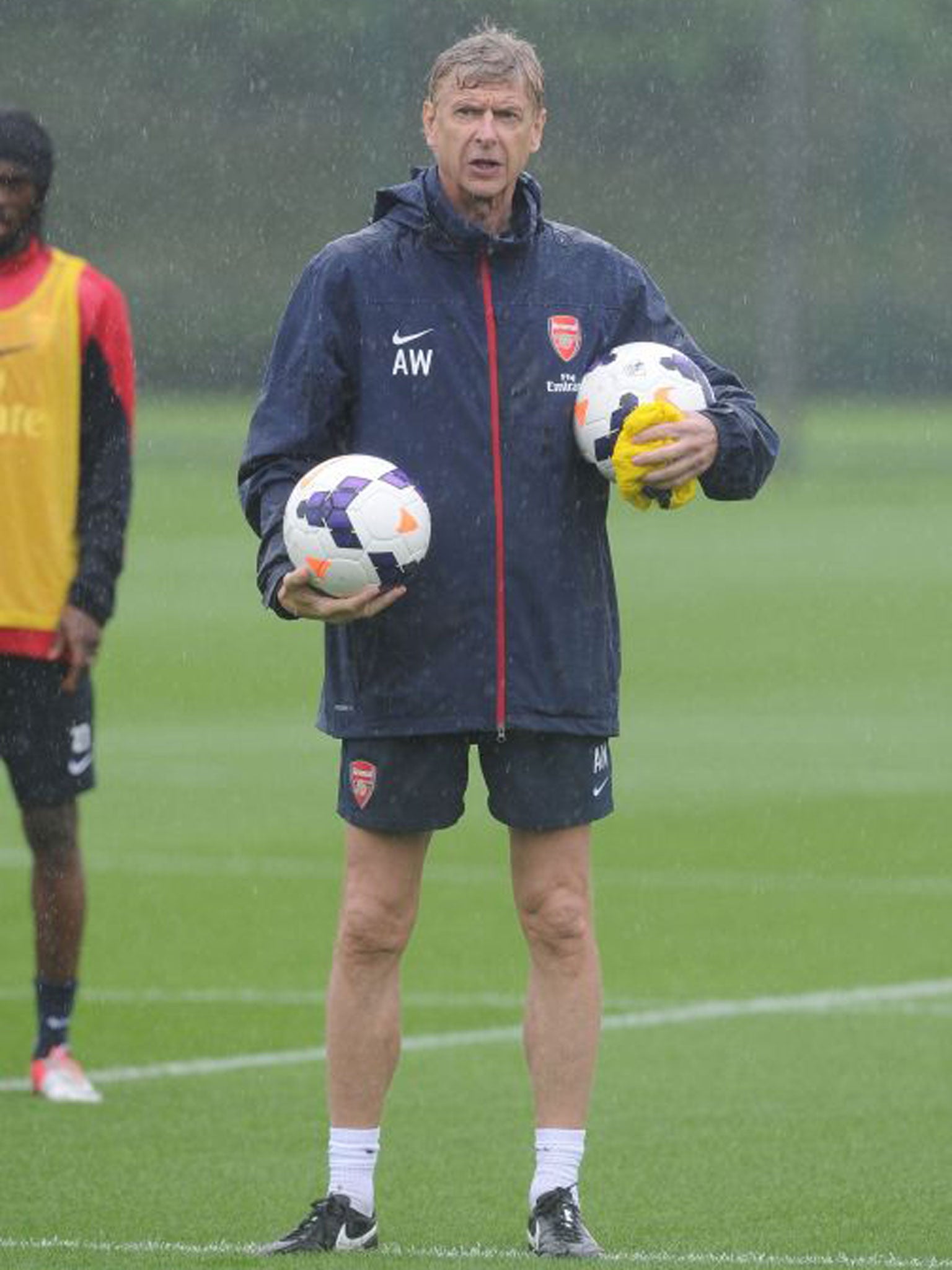 A sodden Arsène Wenger during Arsenal training this week
