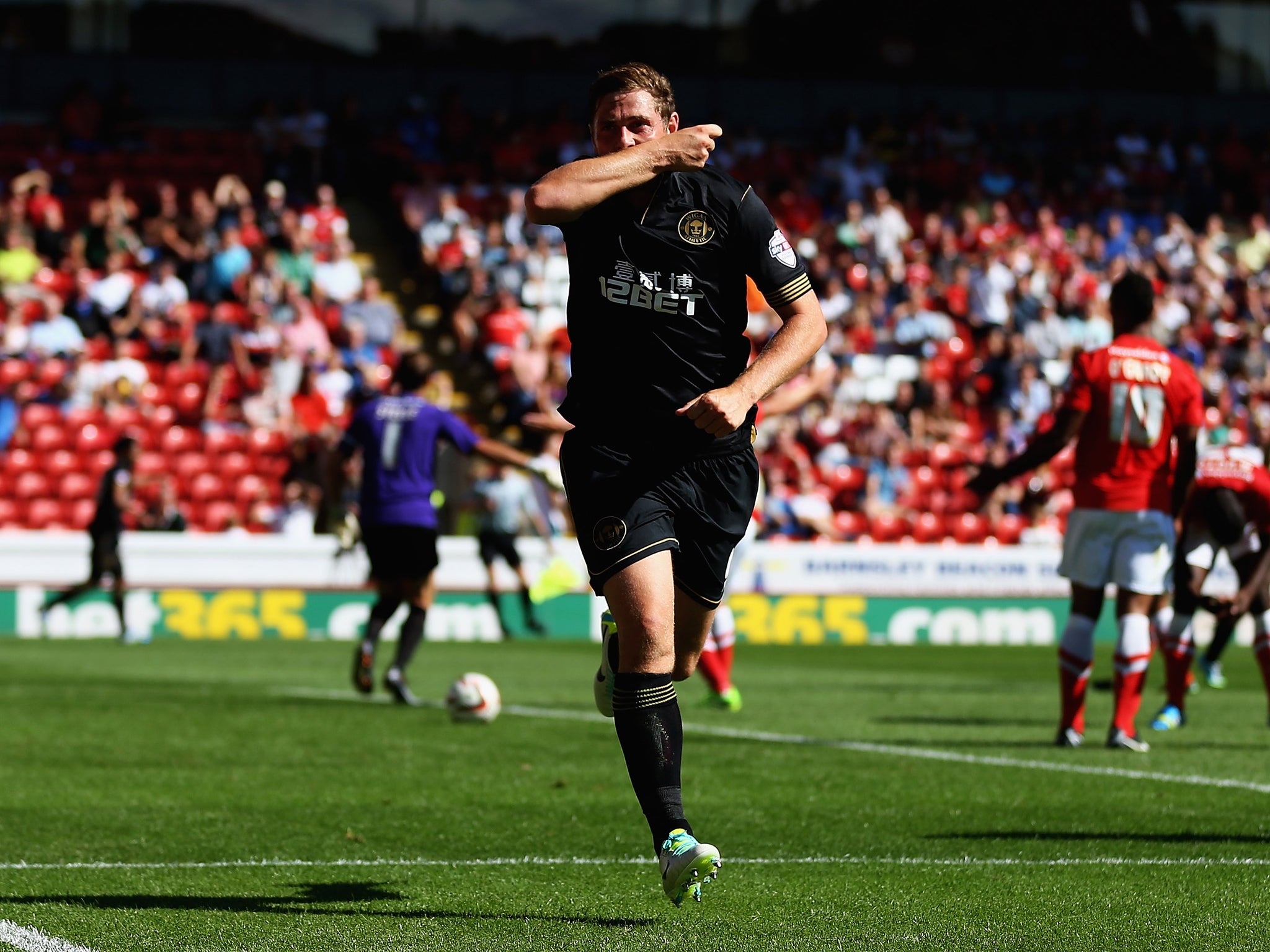 Grant Holt celebrates scoring his first goal for new club Wigan