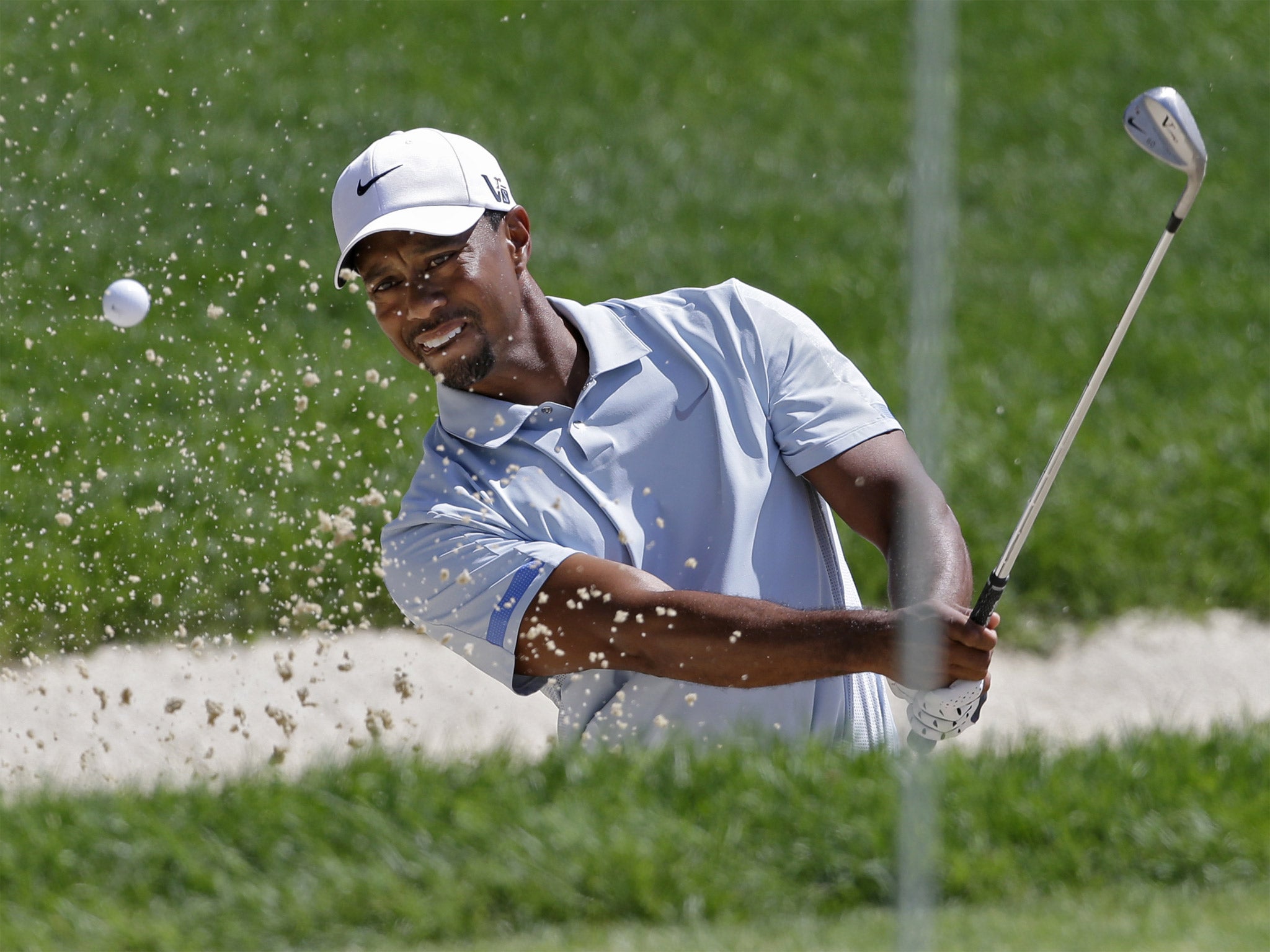 Tiger Woods hits a shot from the bunker on the fifth hole at the WGC-Bridgestone Invitational event