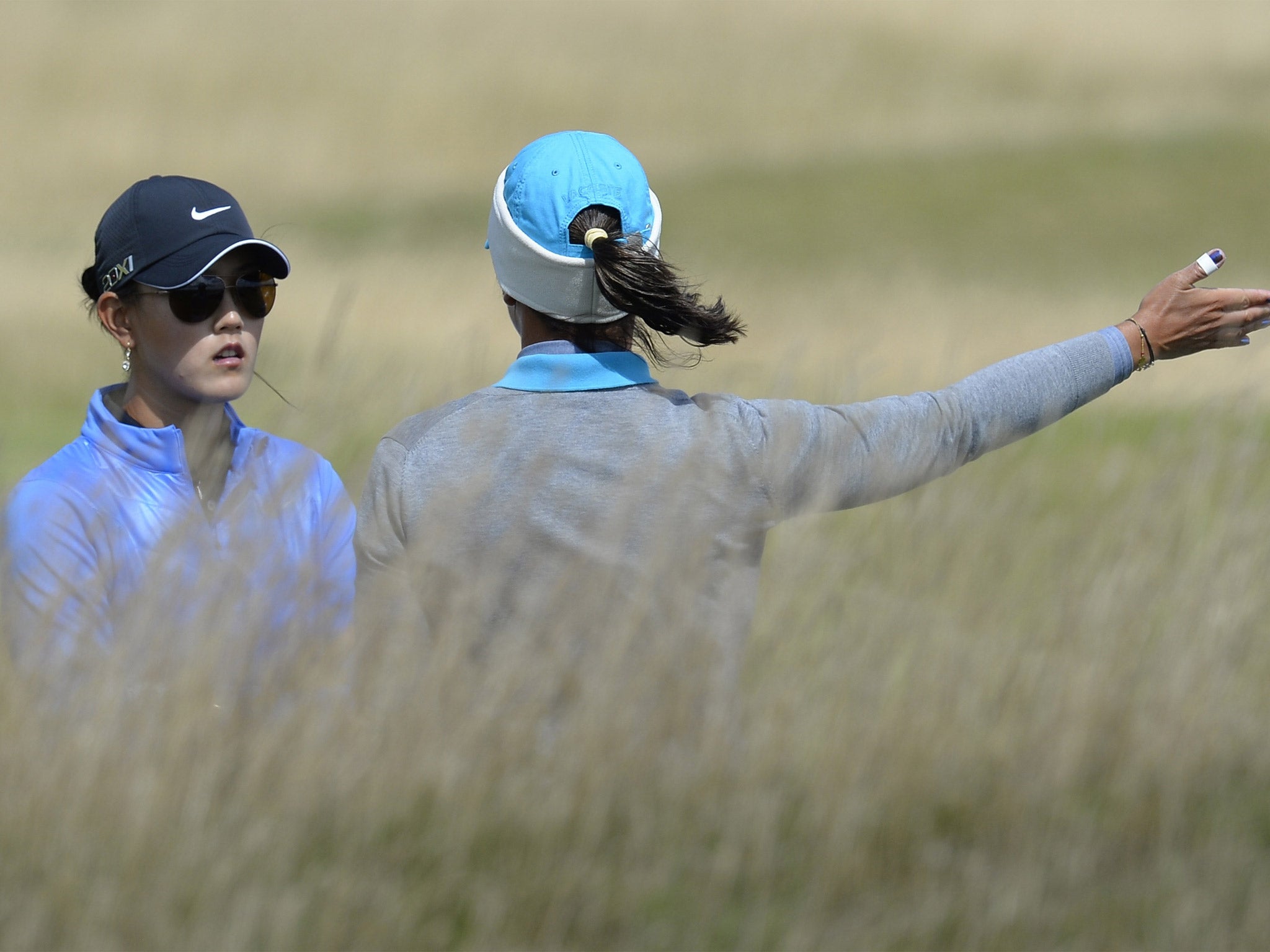 Michelle Wie, (left) and Karine Icher feel the force of the wind
