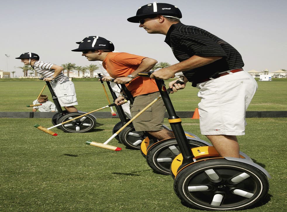 Expatriates play polo on Segway Human Transporters before a charity polo match at Dubai Polo Club