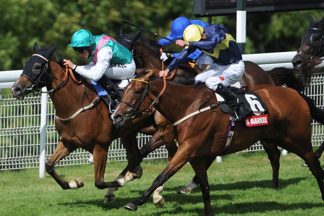 Winsili, left, edges home to take the Nassau Stakes at Goodwood