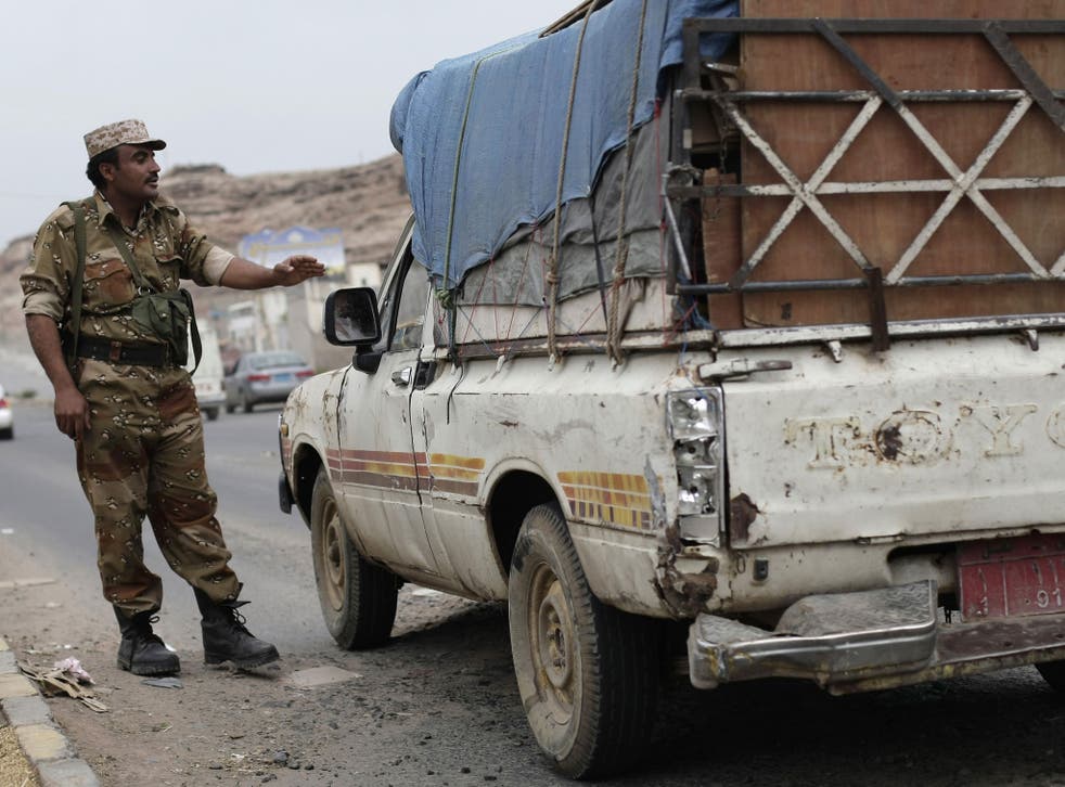 A Yemeni soldier stops a vehicle yesterday at a checkpoint on a street leading to the US Embassy in eastern Sana’a