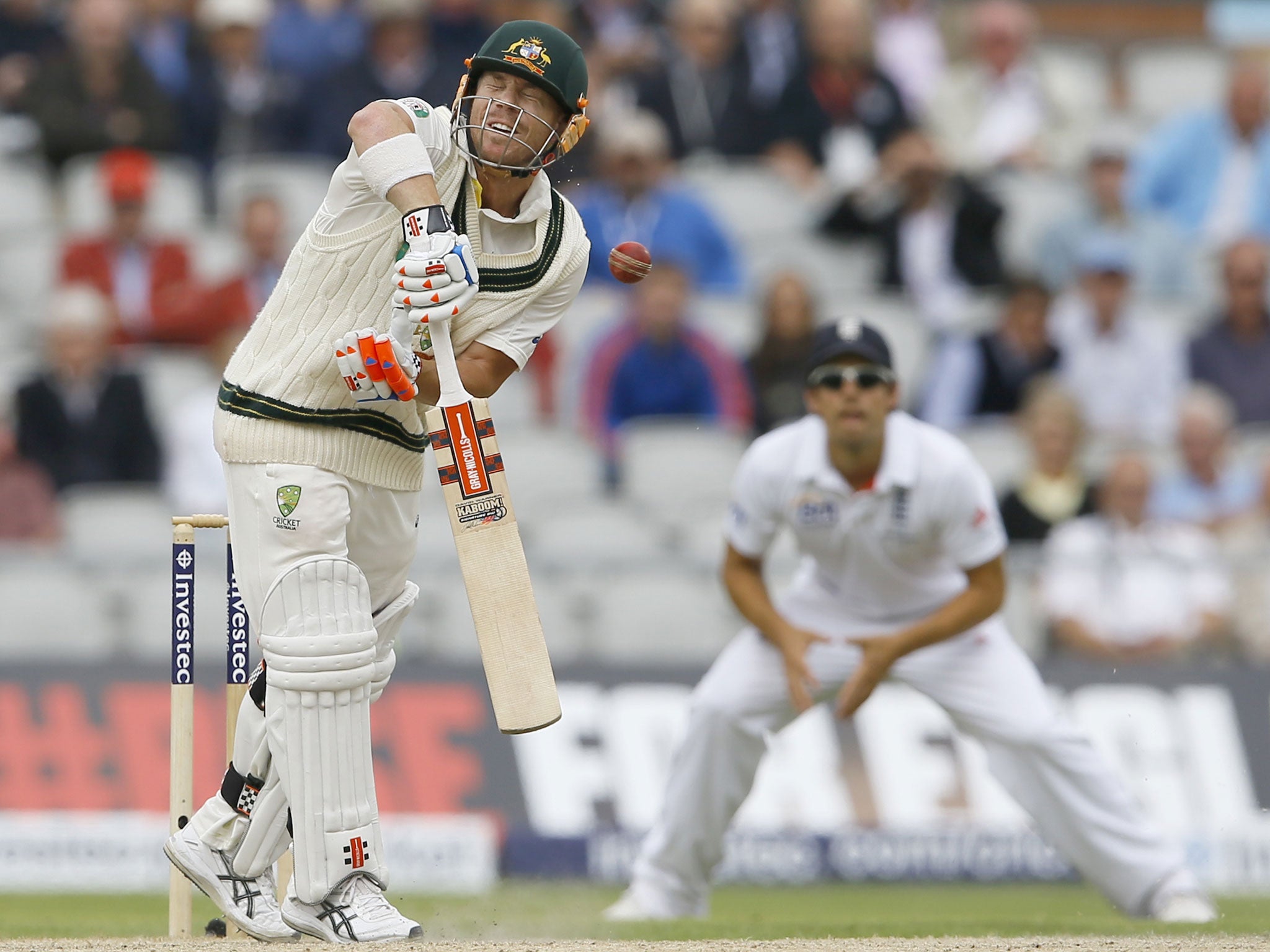 David Warner takes a hit from a Stuart Broad delivery