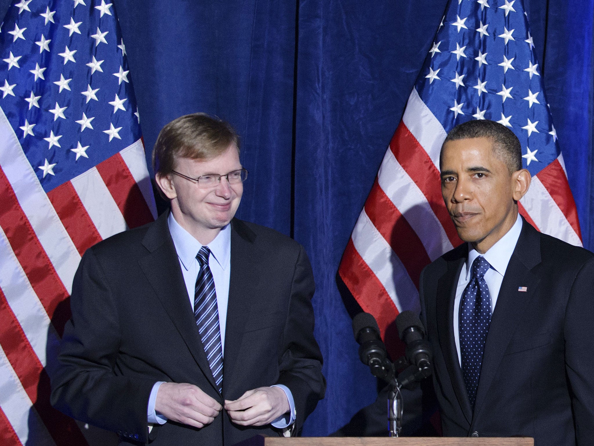 US President Barack Obama speaks as Organizing for Action head Jim Messina (L) looks on during an Organizing for Action dinner on March 13, 2013 at the St. Regis Hotel in Washington, DC. Messina was the manager of Obama's 2012 re-election campaign.