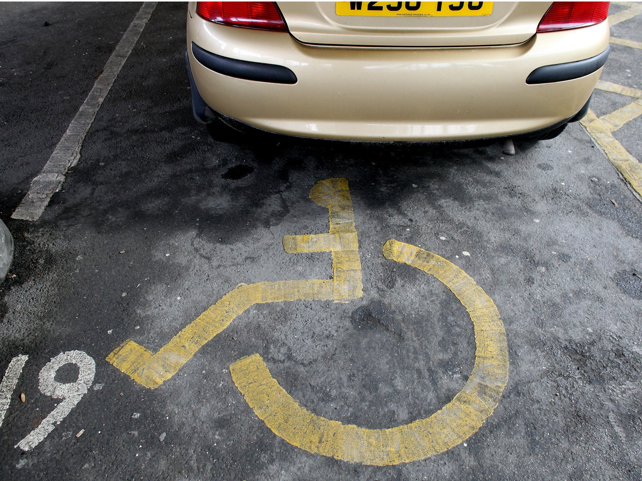 The disabled symbol is seen painted on the ground of a disabled car parking bay on February 16, 2011 in Bath, England.