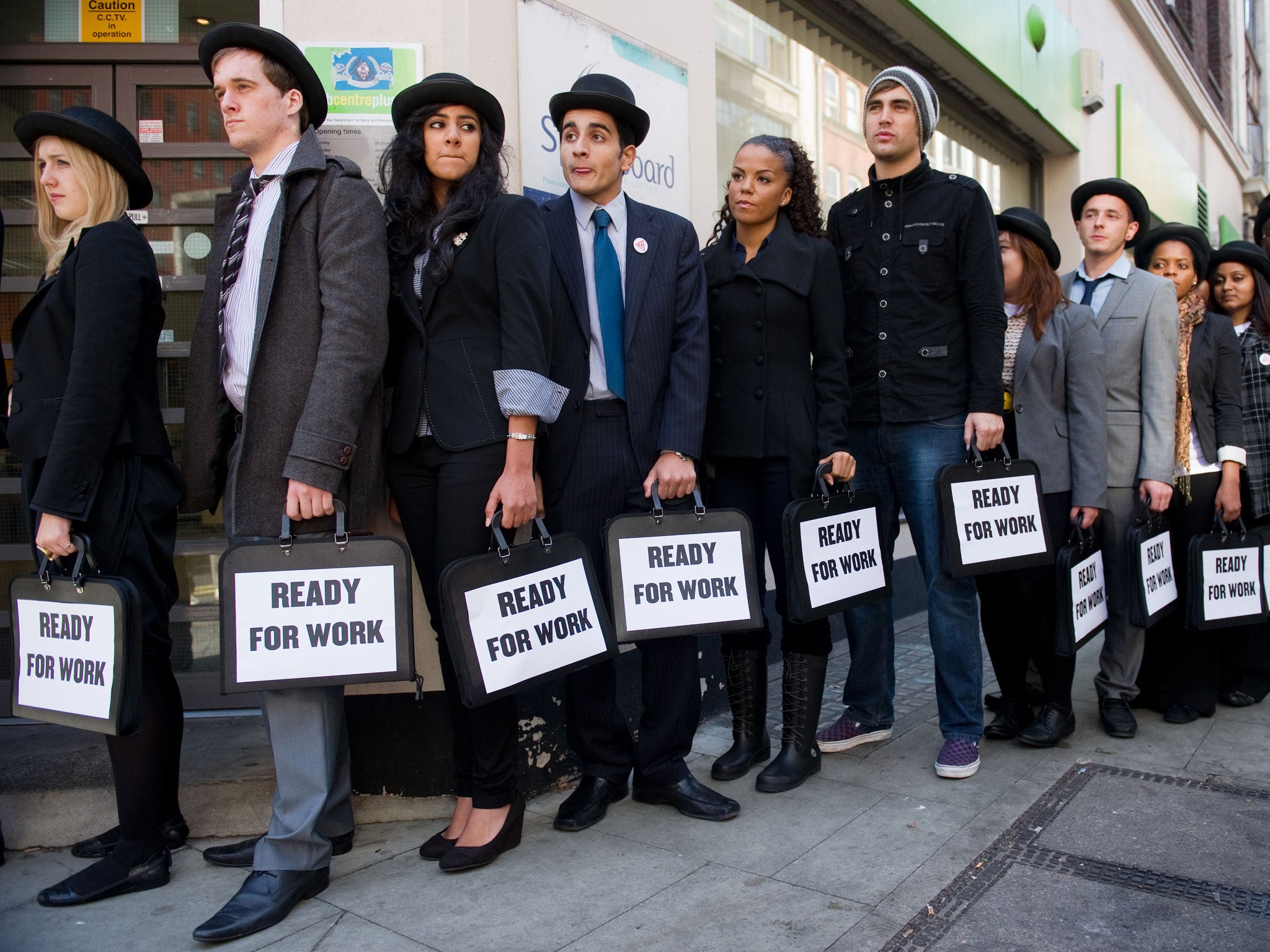 British musicians Miss Dynamite (5th L) and Charlie Simpson (6th L) join unemployed young people as they stand in line outside a job centre in central London during a photocall for the Battlefront Campaign