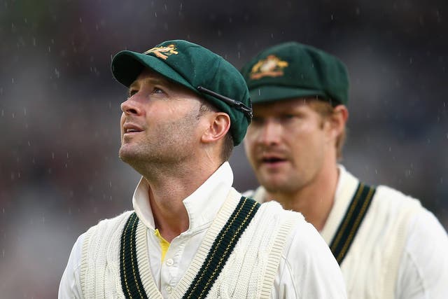 Michael Clarke and Shane Watson of Australia leave the ground after rain stopped play 
