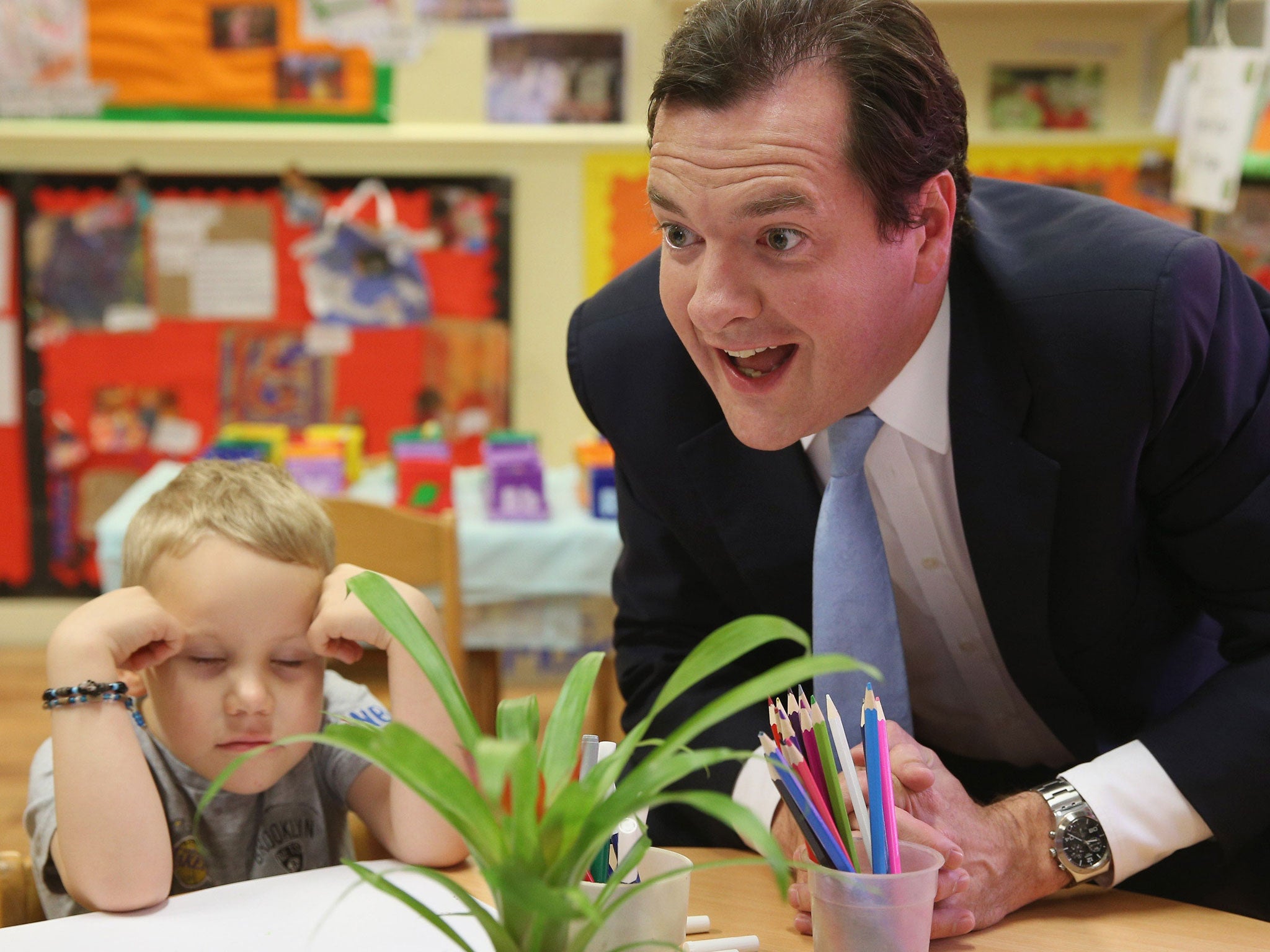 George Osborne with Titas, during a visit to a nursery in Hammersmith