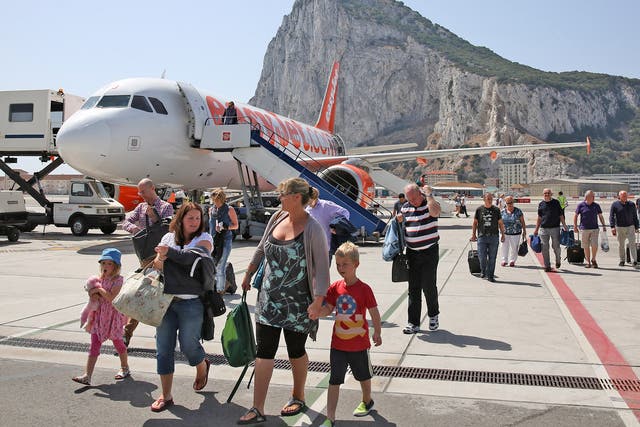 Passengers disembark a flight shortly after landing at Gibraltar International Airport