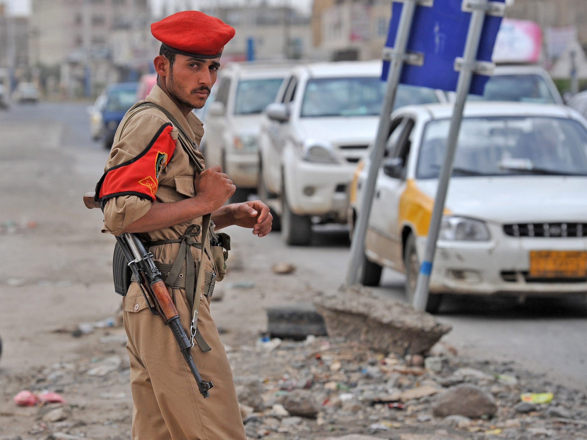 A Yemeni soldier stands guard at a checkpoint on a street leading to the US embassy