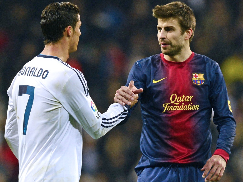 Real Madrid's Cristiano Ronaldo and Barcelona's Gerard Pique during a Copa del Rey tie earlier this year