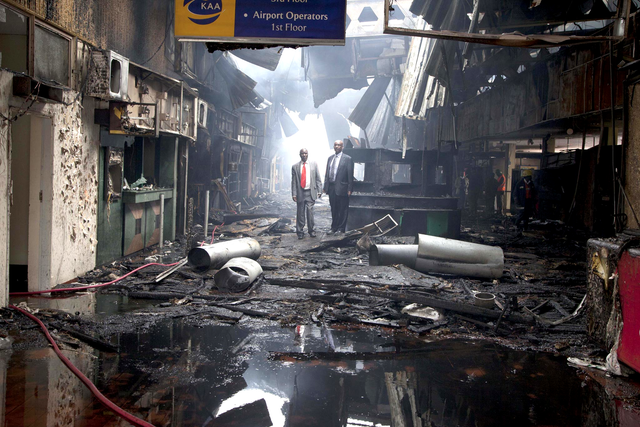Kenyan airport officials view the damage after a fire engulfed the international arrivals area of Jomo Kenyatta International Airport, in Nairobi, Kenya