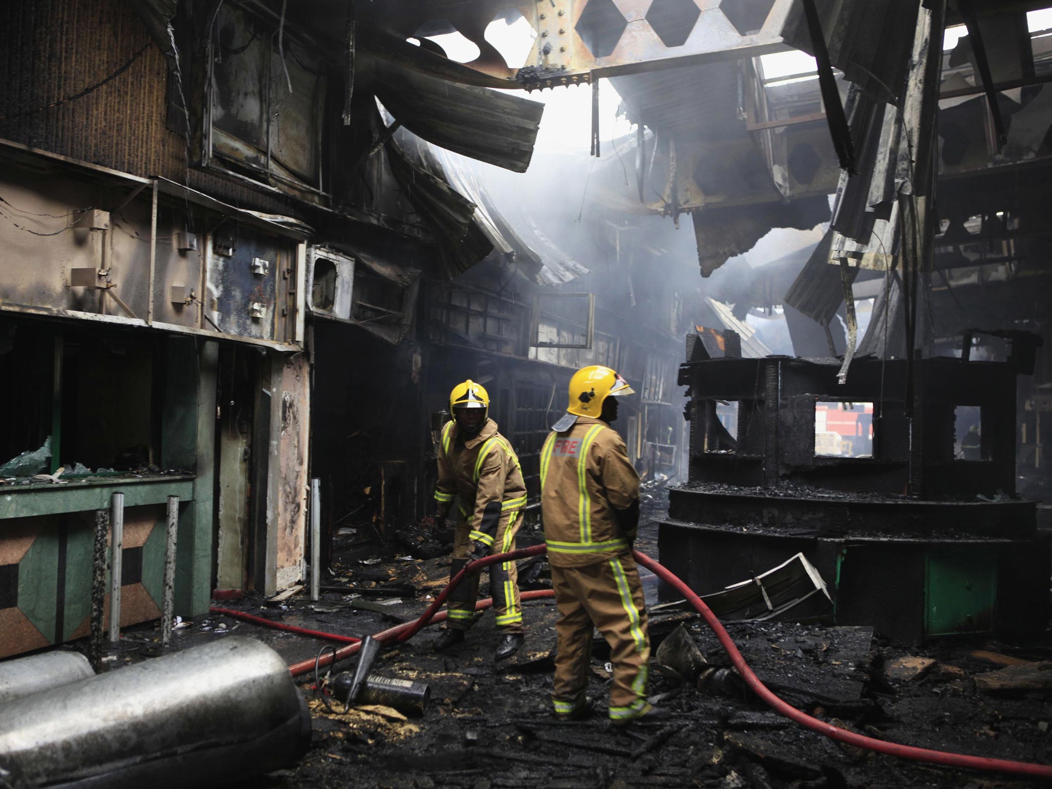 Fire fighters put out a fire at the Jomo Kenyatta International Airport in Kenya's capital Nairobi