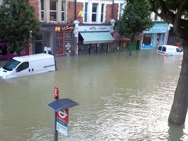 Flooded streets after burst water main in Herne Hill, London