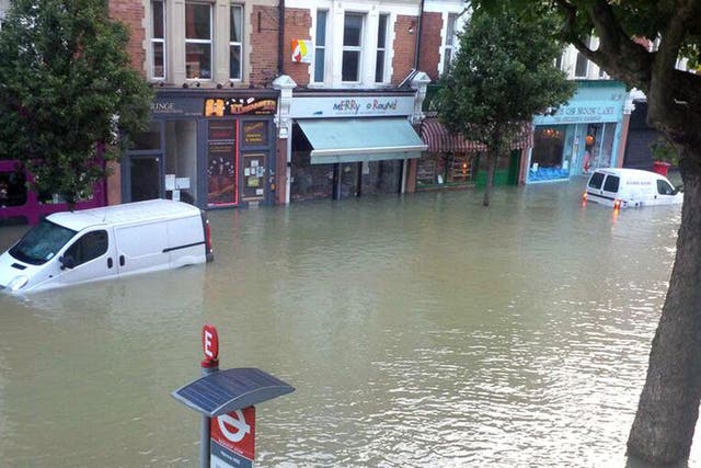 Flooded streets after burst water main in Herne Hill, London