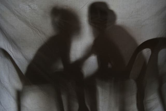 The shadow of two teenage girls rescued from a cyber sex den is seen in this photo taken at Preda Foundation office on December 2, 2010 in Olongapo City, Zambales province, north of Manila.