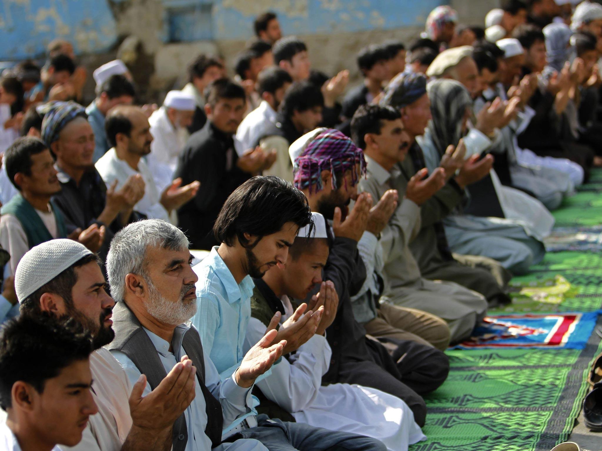 Afghans take part in morning prayers on Eid-al-Fitr outside the Shah-e Doh Shamshira mosque