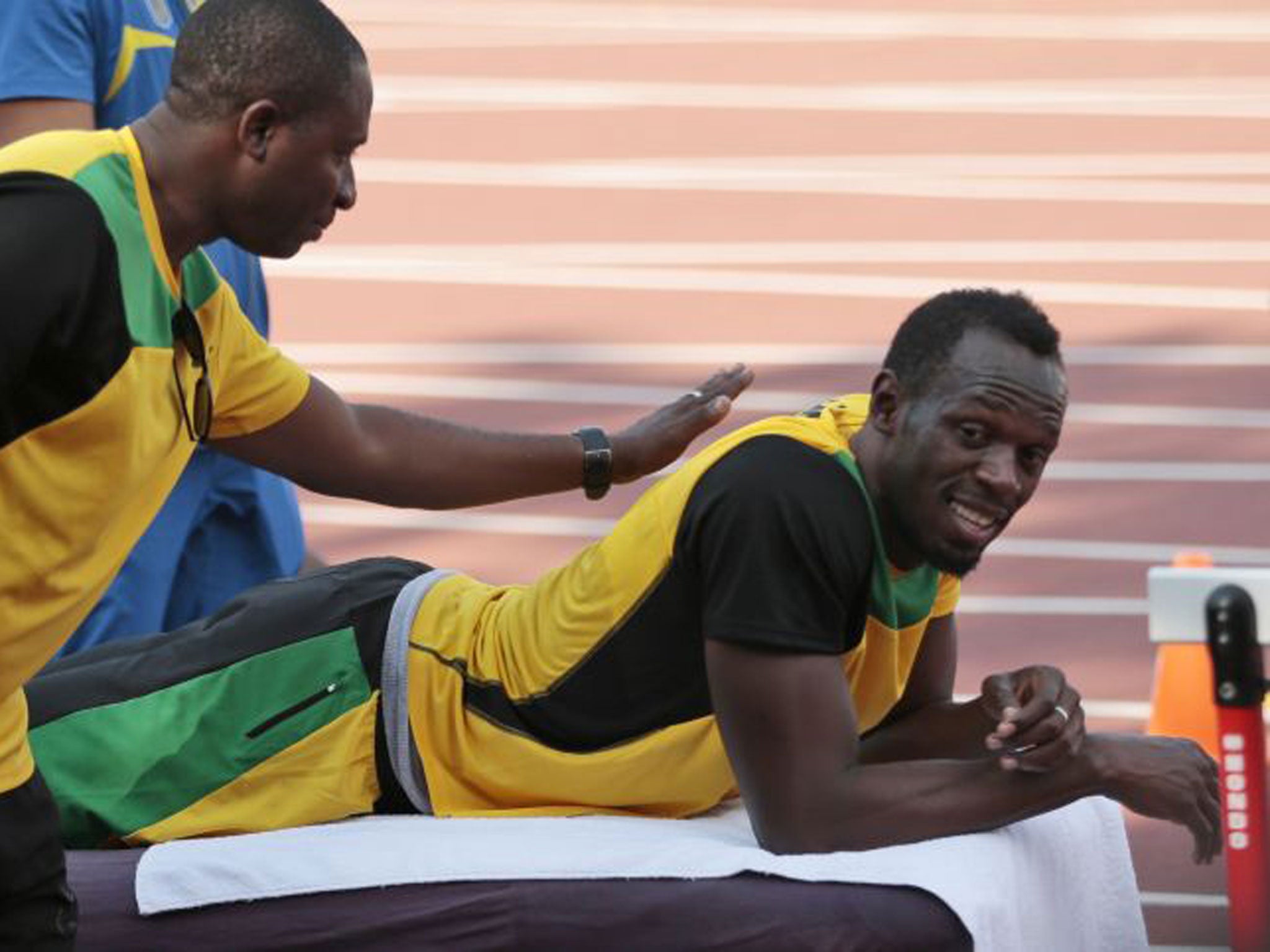 Usain Bolt waits for a massage during Jamaica’s training session