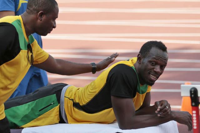 Usain Bolt waits for a massage during Jamaica’s training session