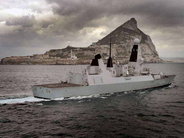 HMS Dragon is shown passing the Rock in March