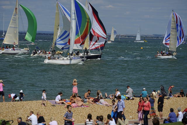 Some watch, some don't, as the AAM Cowes Week competitors race along the beach to the finish line.