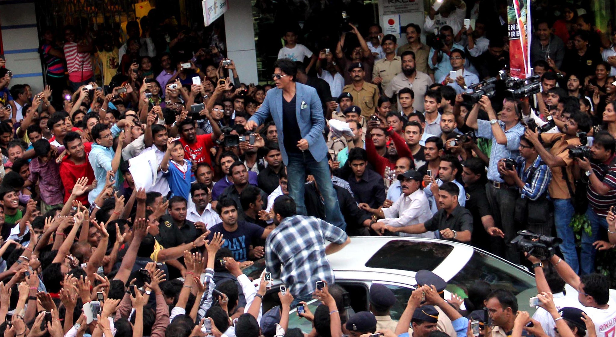 Shah Rukh Khan greets fans gathered in Mumbai to meet the Bollywood star