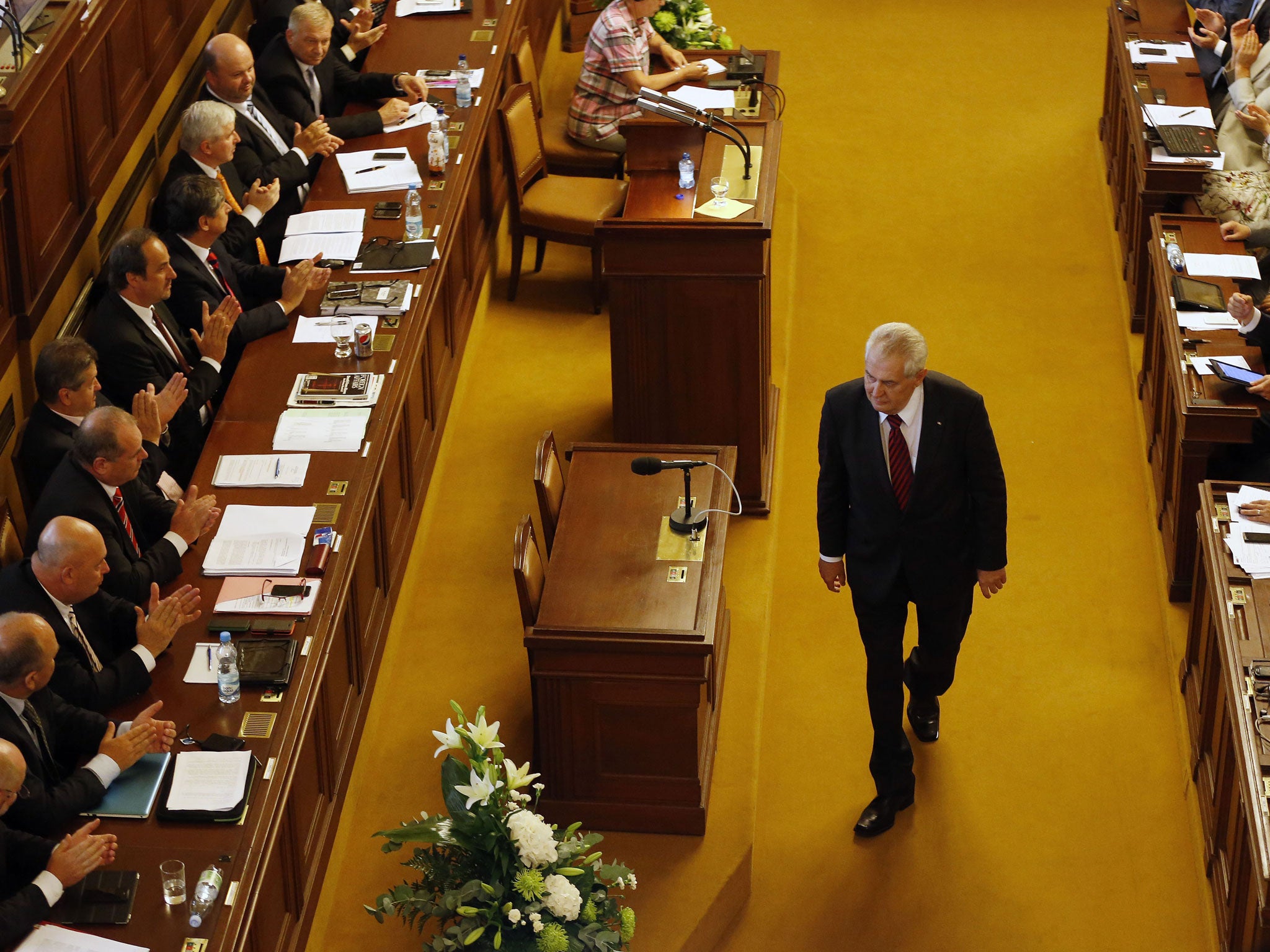 Milos Zeman walks past representatives after delivering a speech during a Parliament session in Prague. Czech Republic's Parliament gathered for a confidence vote for a newly appointed government led by Jiri Rusnok