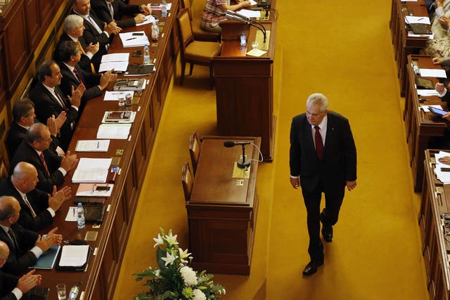 Milos Zeman walks past representatives after delivering a speech during a Parliament session in Prague. Czech Republic's Parliament gathered for a confidence vote for a newly appointed government led by Jiri Rusnok