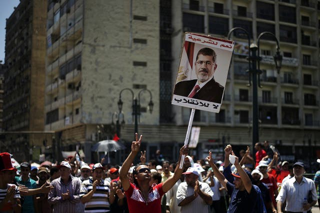 Supporters of the deposed President Mohamed Morsi protest in Cairo yesterday. Rare co-operation between Egypt and Israel saw five suspected Islamic militants killed in the Sinai desert by an Israeli rocket strike
