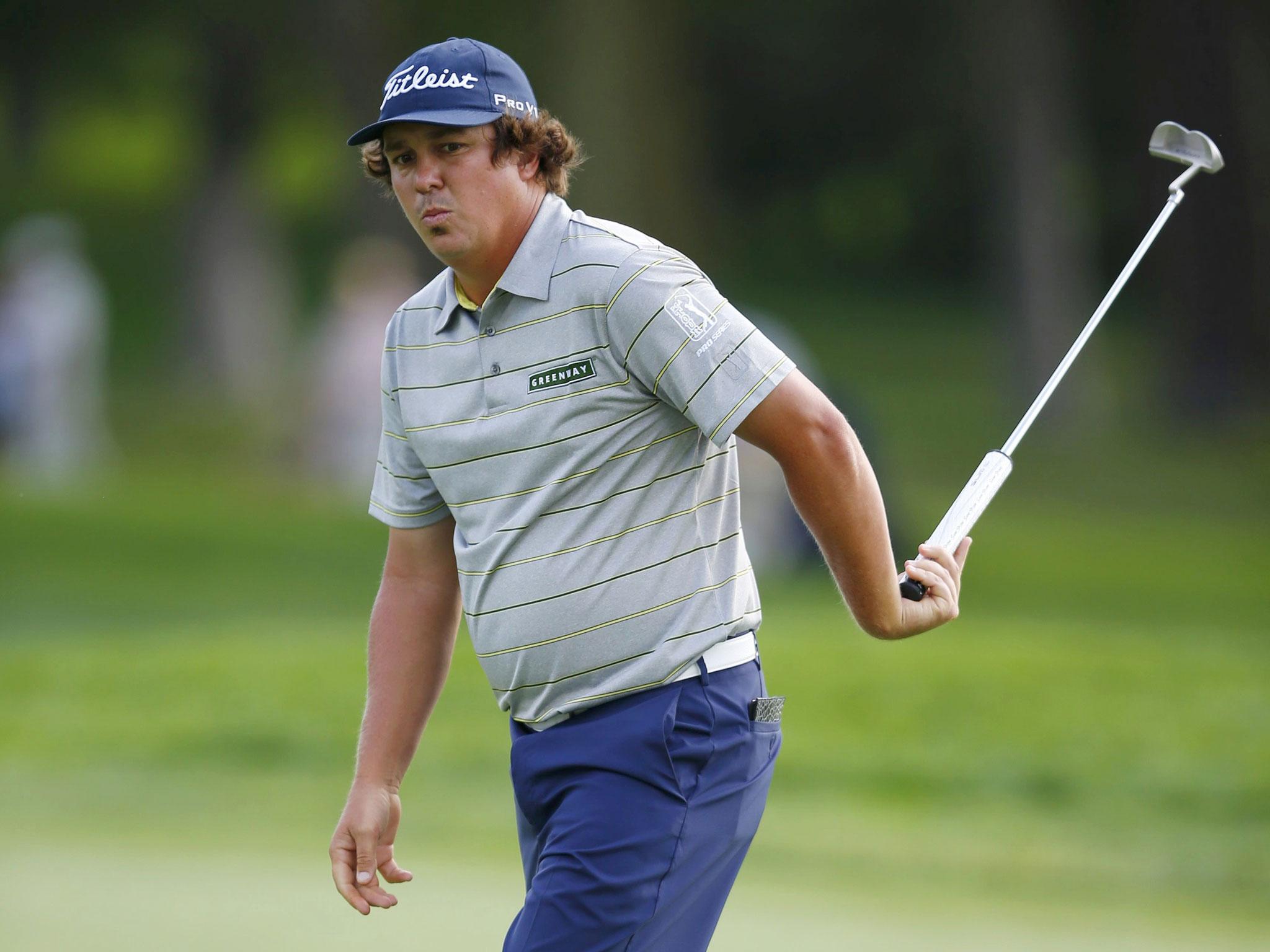 Jason Dufner reacts after missing his putt on the 17th green