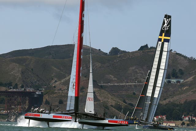 Team Luna Rossa Challenge (L) is skippered by Massimiliano Sirena against Team Artemis Racing (R) skippered by Iain Percy during race three of the Louis Vuitton Cup 