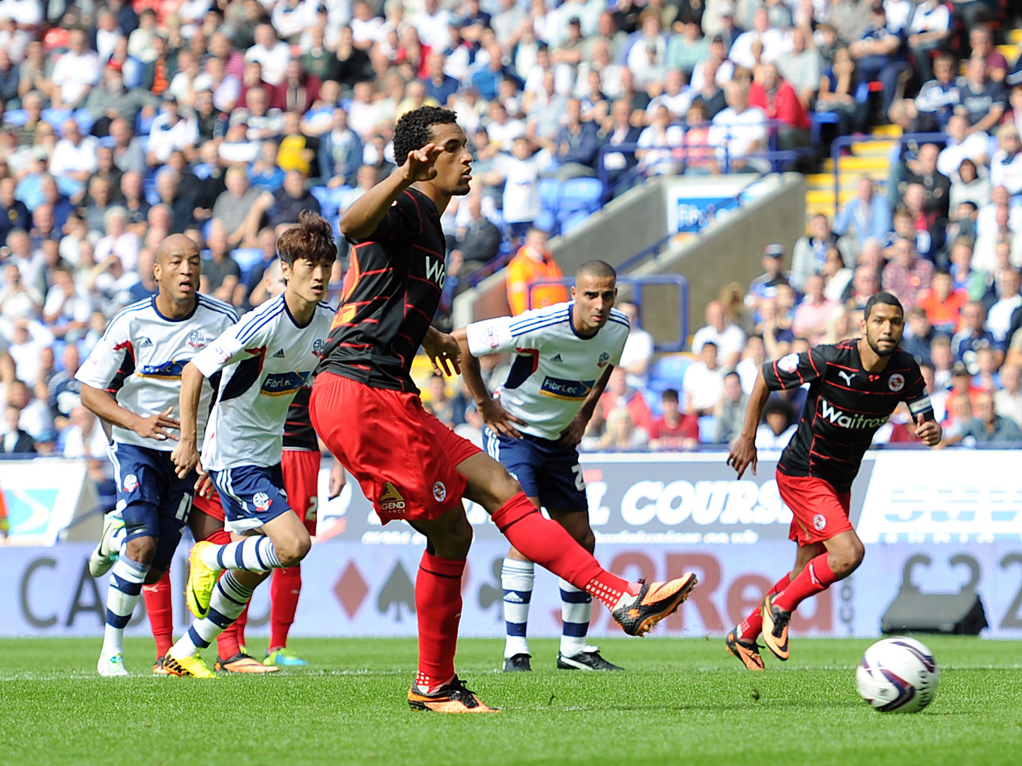 Nick Blackman slots home a penalty to give Reading a share of the points with Bolton