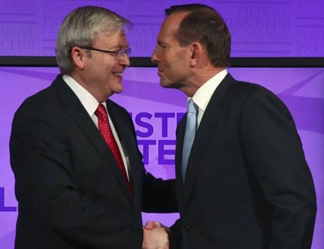 Kevin Rudd (left) and Tony Abbott shake hands before the debate