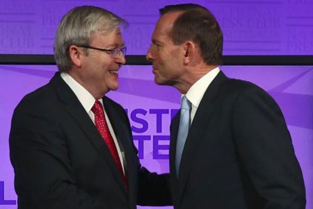 Kevin Rudd (left) and Tony Abbott shake hands before the debate