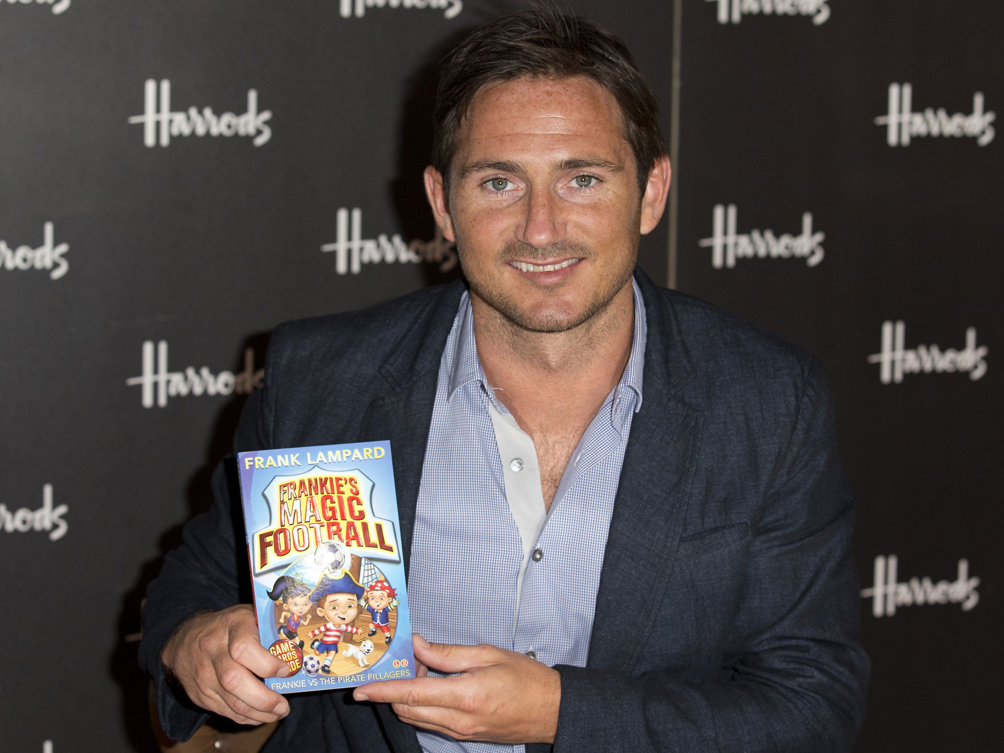 England and Chelsea football player Frank Lampard poses for photographers before signing copies of his new children’s book Frankie’s Magic Football: Frankie vs the Pirate Pillagers in London on June 22, 2013.