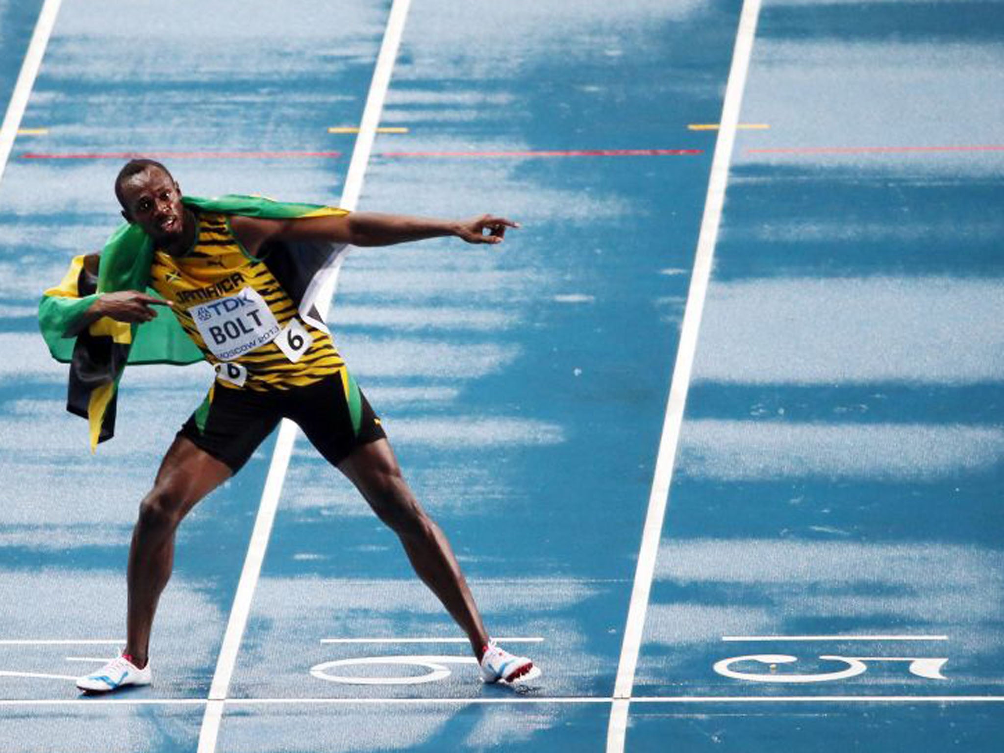 Bolt celebrates after claiming the men's 100m title on the rain-soaked track in Moscow