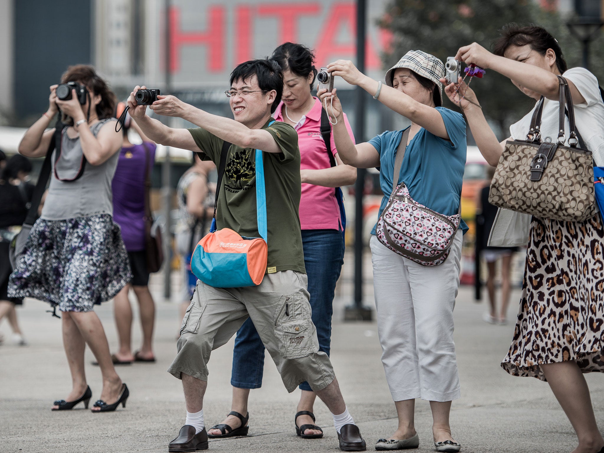 In this picture taken on August 28, 2012, tourists from mainland China take pictures during a visit to Hong Kong.