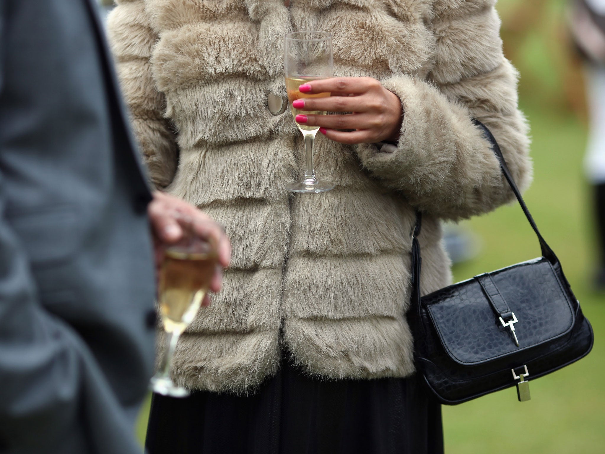 A couple drink champagne at the 'Salon Prive' luxury and supercar event on June 22, 2011 in London, England.