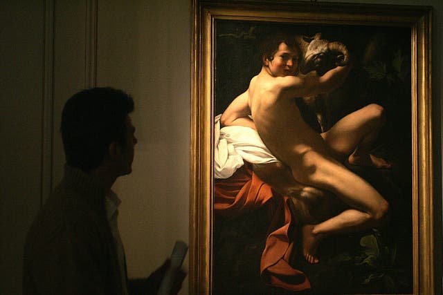 A visitor looks at 'Saint John the Baptist', a 17th century painting originally attributed to Michelangelo Merisi da Caravaggio, on display at Athens' Museum of Cycladic Art 27 April 2006.