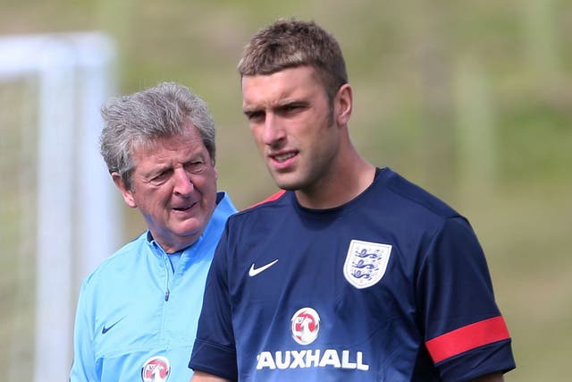Rickie Lambert trains in front of manager Roy Hodgson