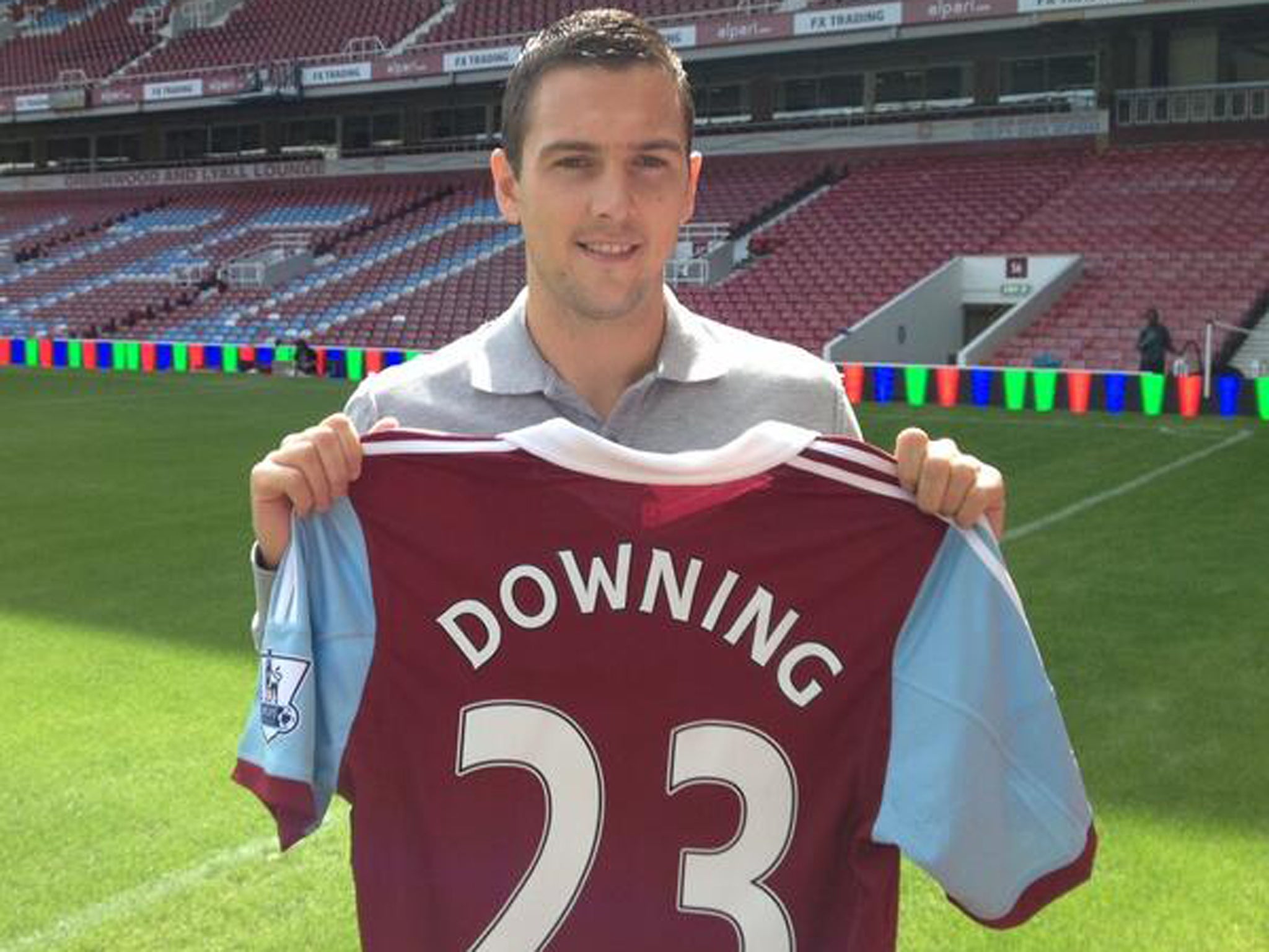 Stewart Downing poses with his new number 23 shirt after completing his move to West Ham