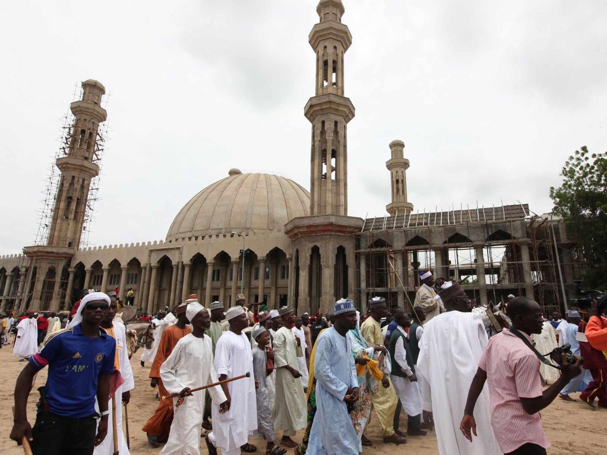 In this photo taken last Thursday, Nigerian Muslims walk past an uncompleted mosque in the Borno region's Maiduguri. At least 44 were killed just 35km away on Sunday, 11 August