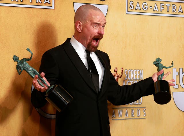 Actor Bryan Cranston poses backstage with his awards for outstanding male actor in a drama series for "Breaking Bad" and for outstanding cast in a motion picture for "Argo" at the 19th annual Screen Actors Guild Awards in Los Angeles, California January 2